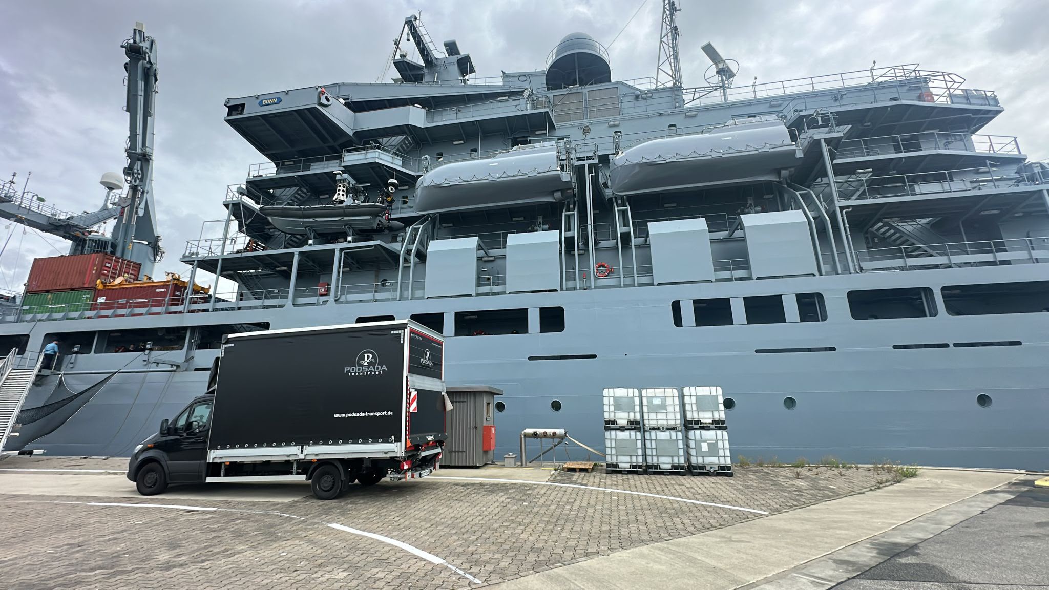 Cargo delivery at the seaport – Podsada Transport truck next to a cargo ship