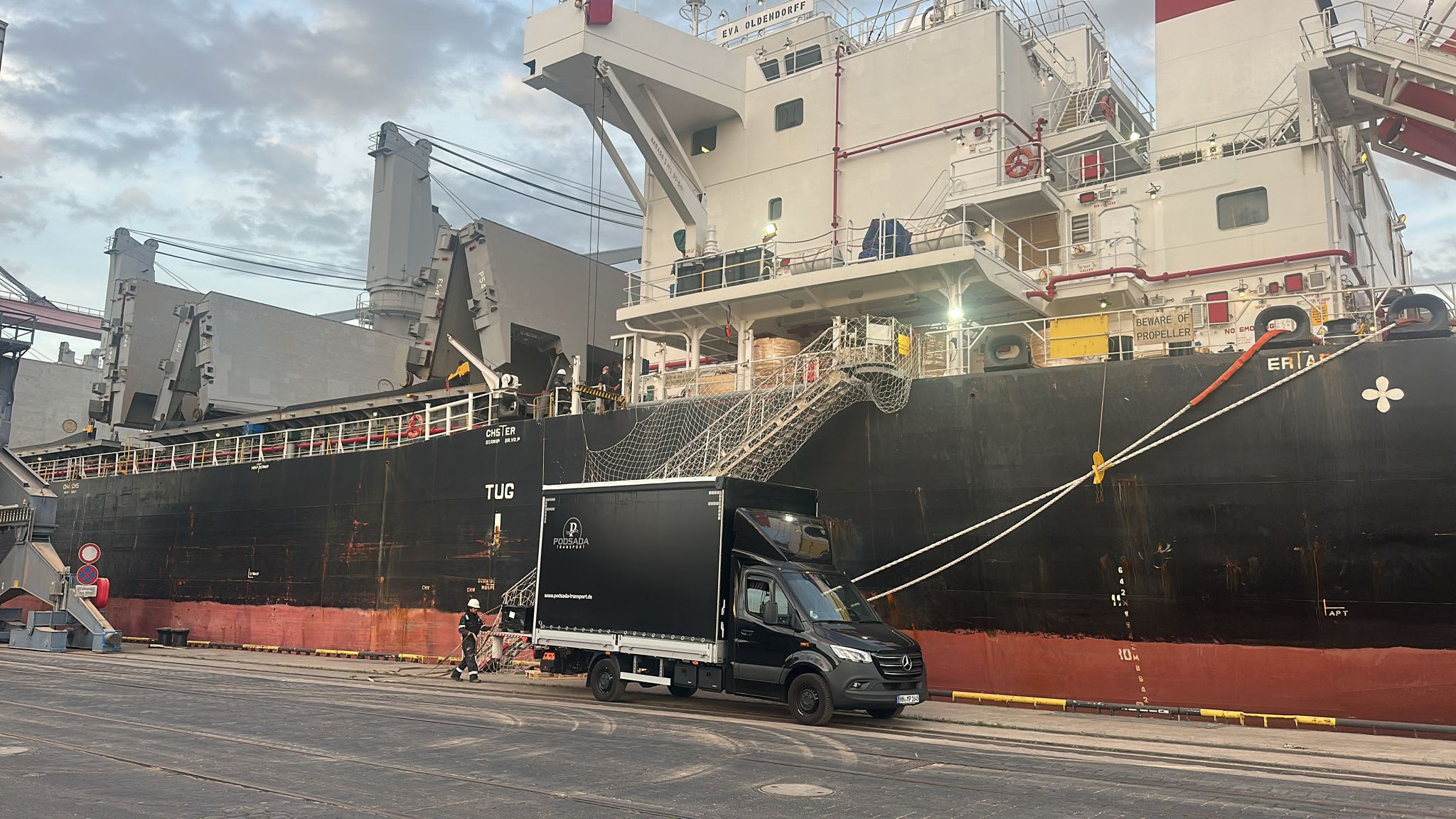 Podsada Transport truck at a cargo ship in the port – maritime logistics Hamburg