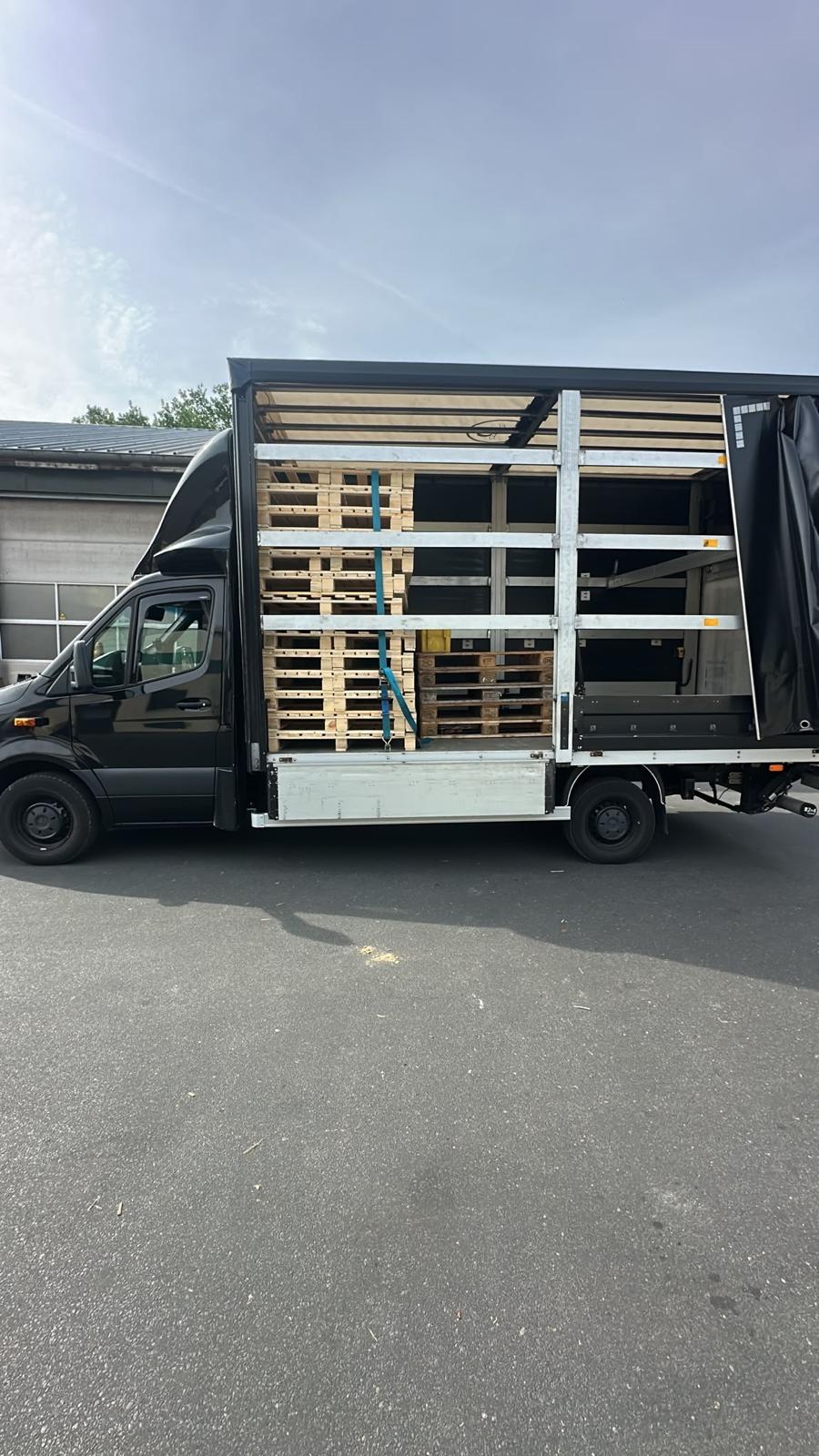 Trailer loaded with wooden pallets – pallet transport Germany